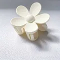 Close-up detail of a matte white flower-shaped hair claw clip for elegant styling - 7.5CM (Bulk) / White