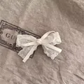 Macro view of a vintage beige lace bow hair clip with elegant floral embroidery details - Lace Bow Hair Clip / Beige