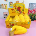 Detail view of a hand squeezing a large 33cm corn-shaped slow rebound squishy toy - Jumbo Corn Squishy / 25cm (Pack of 8)