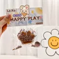 Detail view of a chocolate cat paw squishy stress relief toy inside its cute retail bag - Chocolate Cat Paw / Squishy Toy With Small Gift