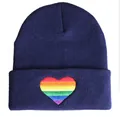 Detailed macro view of vibrant rainbow heart embroidery on a navy blue knitted beanie - Adjustable / Rainbow Navy Blue