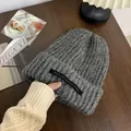 Cozy warm grey knitted beanie hat featuring a unique casual black tag detail for winter - One Size / Long Tag Style / Gray