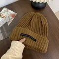 Cozy brown ribbed knit beanie hat for winter warmth featuring a stylish casual brand tag. - One Size / Long Tag Style / Brown