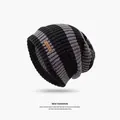 Stylish black and grey striped winter knitted beanie hat for men and women, warm and cozy - One Size / Striped / Black and Gray