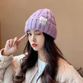 Warm purple knitted beanie hat for winter featuring a stylish white label detail - One Size / Twisted Chain / Purple