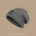 Slouchy gray knitted beanie for winter warmth with a black tag detail - One Size / Square Tag Style / Gray