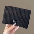 Stylish black ribbed knit beanie hat with "GRANI" brand tag for winter warmth and comfort - One Size / Headband Style / Black