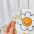 Handmade jasmine flower resin ball keychain with yellow bell in a clear storage bag - Jasmine Daifuku Squishy Pendant With Bell