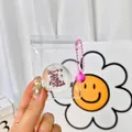 Miniature chocolate Daifuku style squishy toy pendant featuring pink bell and bead chain - Chocolate Daifuku Squishy Pendant With Bell
