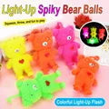 Colorful glowing squishy bear toys in multiple colors on a pink background. - Bear Puffer Ball