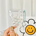 Transparent squishy charm pendant with pearls and stars in a zip bag - Raspberry Tart Squishy Pendant With Bell