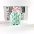 Macro detail view of a soft light blue and pink pineapple squishy stress relief toy - Green