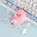 Cute pink banana shaped squishy toy for stress relief presented in a clear plastic bag - Pink