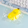 Vibrant yellow banana squishy stress relief toy packaged in a clear protective plastic bag - Yellow