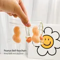 Cute peanut-shaped squishy toy with mini bell keychain in transparent zipper bag. - Peanut Shape Squishy Pendant With Bell