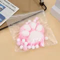Close-up of a 14cm plush cat paw stress relief toy in transparent packaging. - Pink Flocked