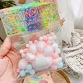 Colorful cat paw squishy stress relief toys in cute retail packaging detail view - Pink Plush