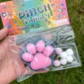 Macro view of the black and pink flocked cat paw squishy toy designed for stress relief - Black and Pink Flocked