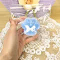 Detailed view of a cute blue cat paw squishy stress relief toy in clear packaging - Sea Salt Cat Claw