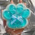 Μάκρο προβολή μπλε διαφανούς squishy πατούσα γάτας με γκλίτερ και φιόγκο - Τεμάχια 12cm / Jumbo Πατούσα Γάτας Θαλασσινό Αλάτι