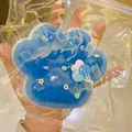 Oversized blue cat paw squishy stress relief toy with translucent slime texture detail - Blue and White Grid