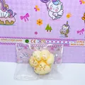 Detail view of a cat paw shaped squishy decompression toy with gold leaf flakes inside. - Osmanthus Style Cat Paw Squishy 7cm