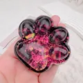 Detailed macro view of the crystal transparent cat paw fidget toy with purple chameleon glitter - Pink