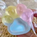 Detailed close-up of a colorful rainbow cat paw squishy toy made from soft TPR material - Three-Color Cat Claw