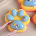 Detailed macro view of a colorful rainbow cat paw squeeze toy made of soft TPR material - Three-Color Rainbow Cat Paw