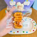 Close-up detail of a Halloween pumpkin squeeze toy inside a clear plastic zipper bag - 8x5cm / Halloween Cream Strip