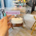Simulation Basque cake squeeze toy presented in clear protective packaging for stress relief - Crepe Cake / Chocolate