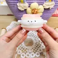 Close-up of a cute animal squishy toy for stress relief with a soft pink and white texture - Pink Gold Coin Dog