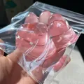 Macro shot of a translucent pink giant 220g cat paw squishy toy in its packaging - Jumbo Cat Paw / 220g/Pack / Transparent Pink