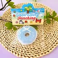 Detail view of the blue donut-shaped TPR squishy toy in colorful beach packaging - Doughnut Style (Sea Salt Blue)