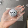 Detailed view of a cute gray seal squishy toy with mini spoon and fork accessory in hand - Seal Fork and Spoon Style / 1 Piece