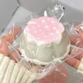 Detailed view of a pink and white dessert-shaped silicone squishy toy in clear packaging. - PVC Bag and Food-Grade Silicone / Cherry Blossom Pink Waffle
