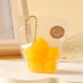 Yellow cube squishy stress relief toy in a transparent fruit-style bag with chain - Diced Mango, 1 Pack