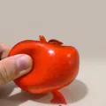 Red translucent slushy apple squishy toy being squeezed by hand for stress relief - Slushy Red Apple