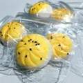 Gros plan de jouets à presser en forme de pâtisserie au jaune d'œuf emballés individuellement - Pâtisserie au jaune d'œuf en PVC antistress (en sachet)