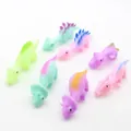 Colorful soft rubber slingshot dinosaur finger toys for stress relief, gag fun and finger play. - Spray Painted Slingshot Dinosaurs