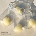 Close-up of mini chick squishy toys in clear packaging with bead chains - Mini Chick (Mao Rong Mu Ji Xiao Ji) / Yellow