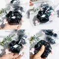 Detailed view of a black glitter cat paw squishy stress relief toy with ghost design - Black Crystal Cat Paw Squishies