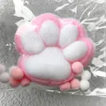 Macro view of a soft pink plush cat paw squishy toy in plastic packaging - Large Style (Jumbo) / 12x11cm