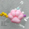 Macro detail of a pink plush cat paw squishy toy inside a clear plastic protective bag. - Mini Size / 6x6cm
