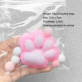 Close-up detail of plush cat paw squishy toy in protective packaging - Medium Size / 7x7cm