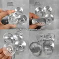 Detailed macro view showing the slow-rebound texture of a clear smiley squishy toy ball - Transparent