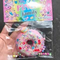 Decompression pink donut squishy toy decorated with colorful glitters in retail packaging - Glitter Pink And White Donut (With Card)