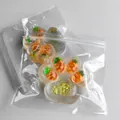 Detail view of a transparent cat paw shaped squishy toy with golden glitter and pineapple inside - Pineapple Style (With Glitter) / 60g Pack / Transparent Glitter Yellow