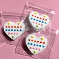 Detailed view of white heart-shaped silicone pop-it toys with colorful dots - Heart / Heart Shaped Colorful Polka Dots