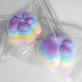 Detailed macro view of fuzzy rainbow cat paw squishy toy inside clear plastic packaging - 7cm Four-Layered Color Cat Paw Squishy (Flocked)